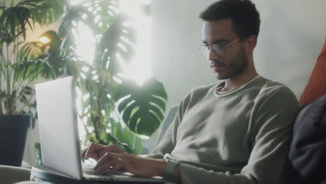 man working on laptop at home