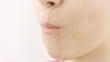 woman eating coated hazelnut in close-up. nuts.