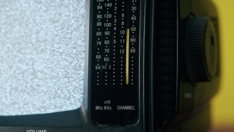 Close-up of an analog television displaying static
