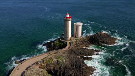 beautiful panorama drone view of the red-roofed petit minou lighthouse by rocky sea peninsula, plouzané, finistère, brittany, france