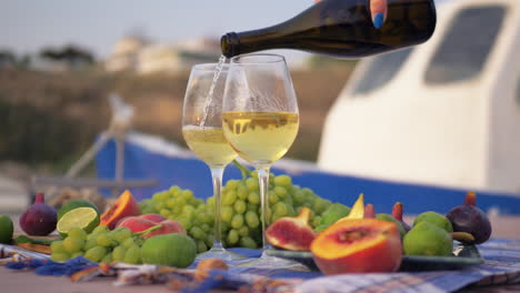 having wine and fresh fruits near the sea