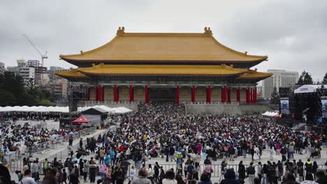 a vibrant time-lapse of busy festival crowds gathering at liberty square, outside the national theater hall in taipei, taiwan, capturing the lively energy and cultural atmosphere of the event.