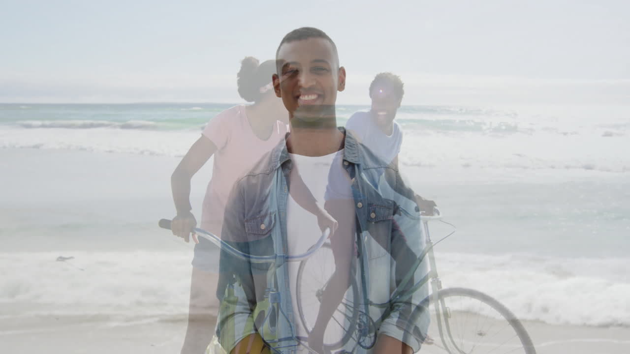 Riding bicycles with friends, man smiling at beach enjoying animation