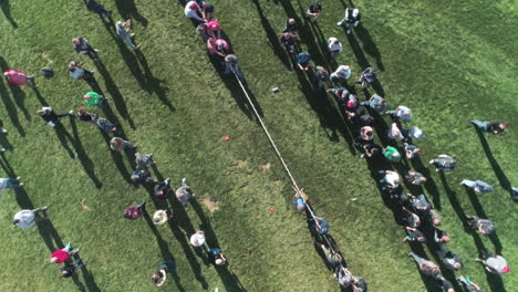 aerial view of large teams playing tug o' war