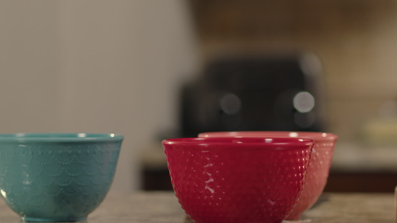 Woman's hand placing minced onions in to a bowl with knife