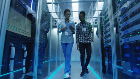 it professionals working and inspecting servers in a data center