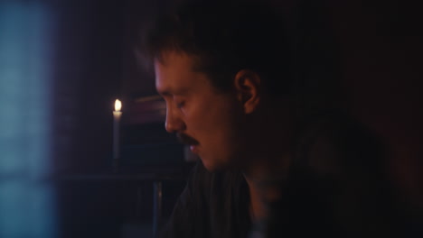 man focused by candlelight