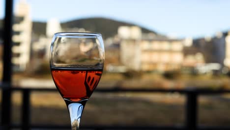 wine glass appears to float against urban backdrop