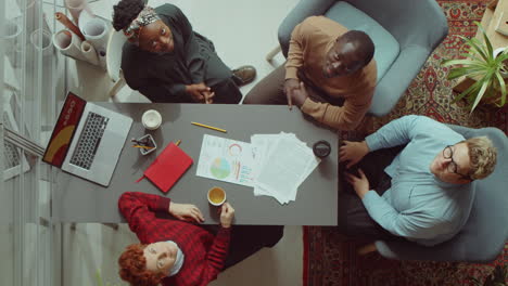 top down of business team posing for camera on office meeting