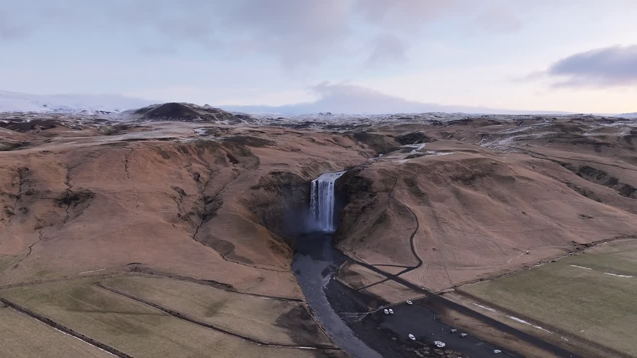 Skógafoss waterfall flowing through a warming valley below Eyjafjallajökull. Skógar, Iceland