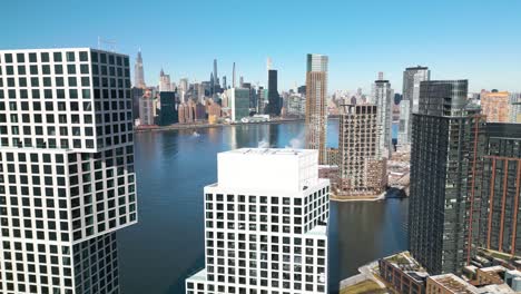 drone flies over modern skyscraper, reveals manhattan nyc buildings on cold day