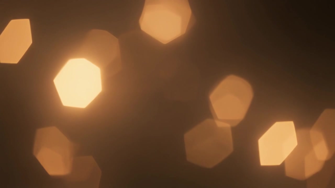 Sfondo Astratto di Luci Bokeh Esagonali Dorate Tenui