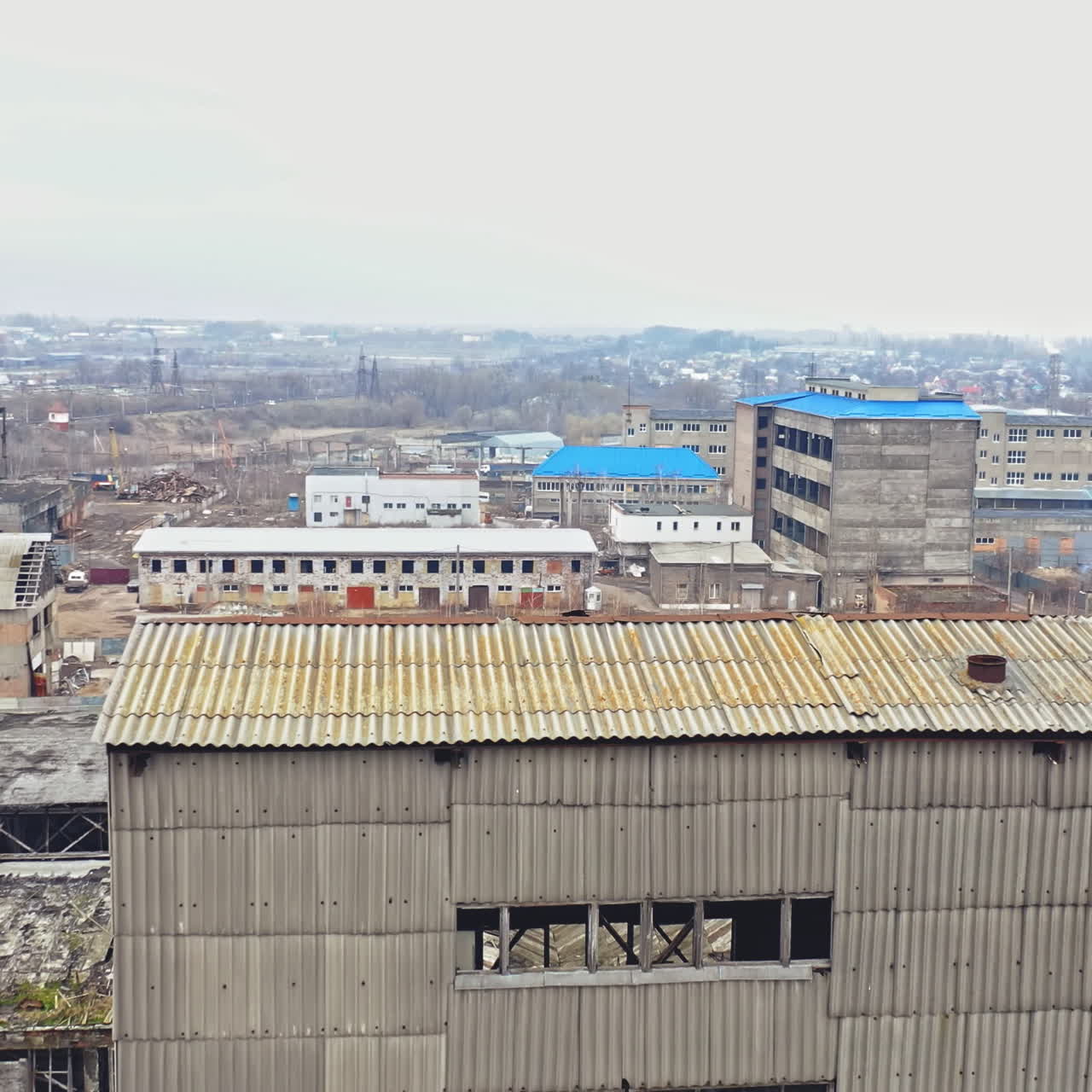 Birds fly over the desolate district with many abandoned buildings in a big city after the military actions. Flying over the ruined city