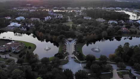 Luftaufnahme-Einer-Brücke,-Die-Bei-Sonnenuntergang-In-Ein-Abgeschiedenes-Luxusviertel-Im-Norden-Floridas-Führt,-Das-Von-Dichtem,-Unbebautem-Wald-Umgeben-Ist