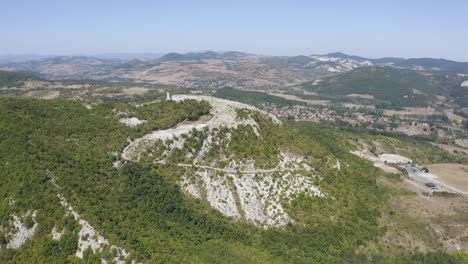 Approaching-drone-shot-of-a-hill-where-the-ancient-rock-city-of-Perperikon-is-located,-in-the-province-of-Kardzhali-in-Bulgaria