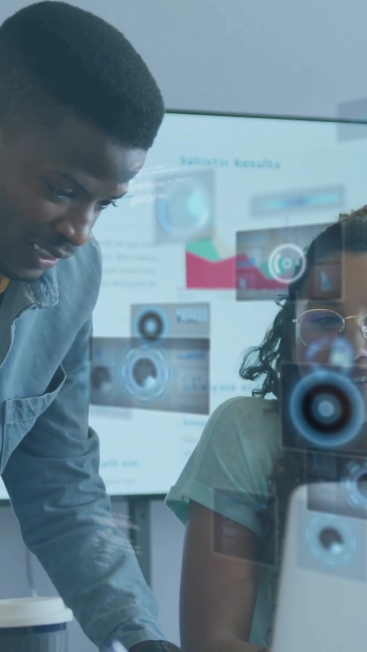 Diverse team collaborating in office with digital data processing animation overlay