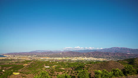 sunny panoramic timelapse of malaga's landscape with mountains and clear blue sky