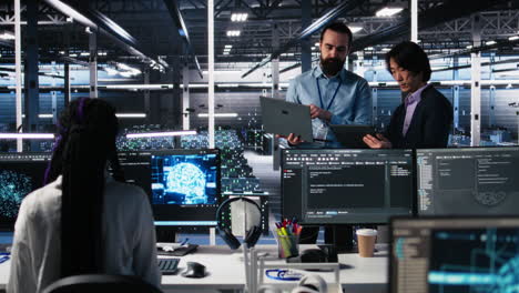 data center manager supervising work done by programmers on neural network