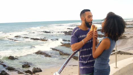 couple eating ice cream cone at beach 4k