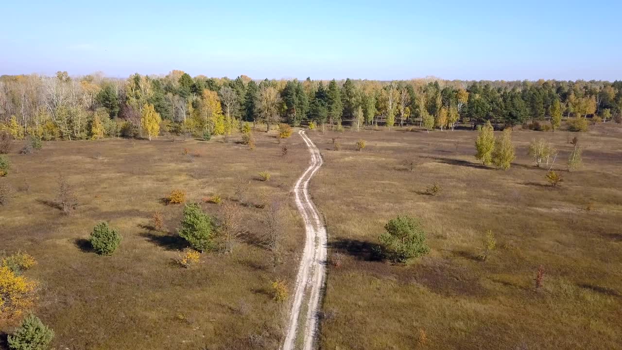 4K  Aerial. Up over  rural road on  field .Autumn time
