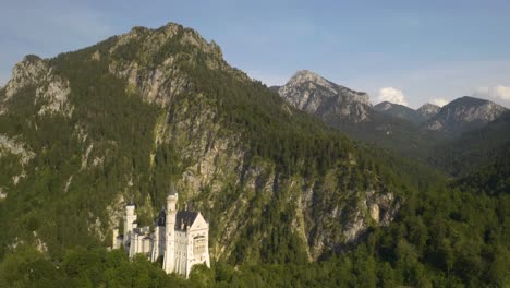 picturesque drone pullback reveals fantasy castle landscape built into alp mountains