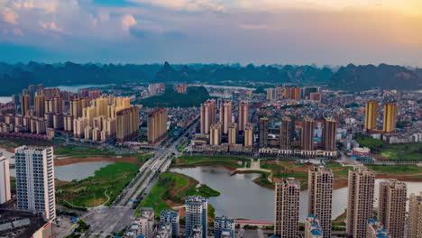 view of car traffic on cross road and highway intersection in modern city with skyline skyscrapers landmark building under blue sky, bridge time-lapse video