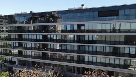 aerial shot showing modern mirrored building in central of buenos aires during sunny day and blue sky