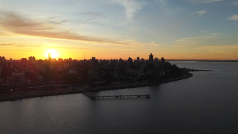 soft golden hour over posadas riverfront with skyline and water blending at horizon