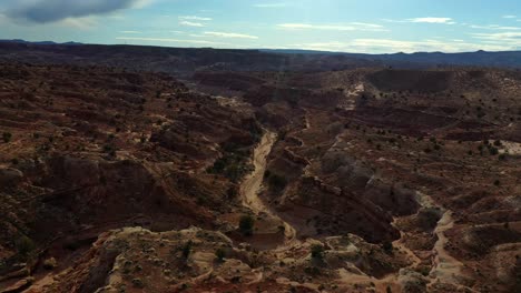 drone approaching towards dry creekbed between colorful canyons in buckskin gulch, southern kane county, utah