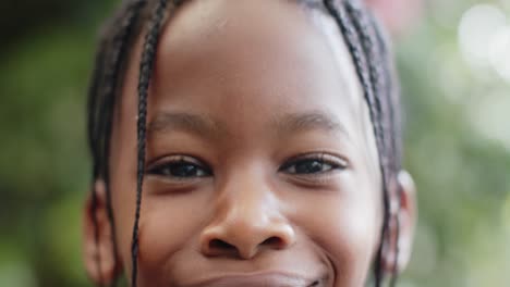 portrait of happy eyes of african american boy in nature, slow motion