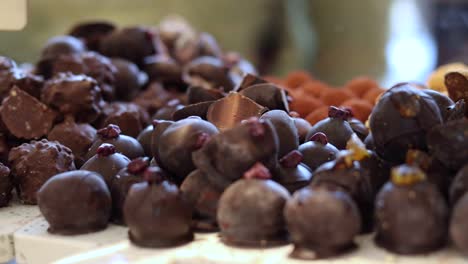 assorted sweet chocolate candies on counter in shop