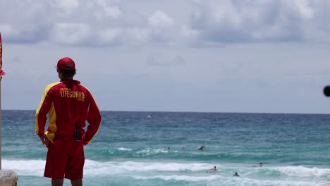 lifeguard monitoring swimmers at the beach