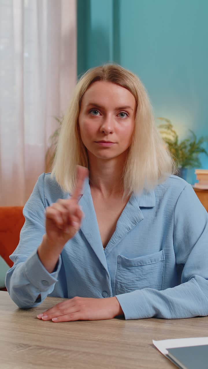 Business woman shakes finger saying no be careful avoid danger mistake disapproval sign at office