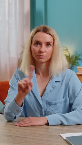 Business woman shakes finger saying no be careful avoid danger mistake disapproval sign at office