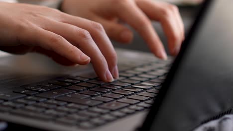 hands typing on keyboard laptop female close-up