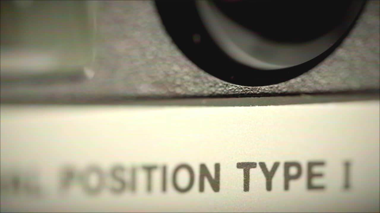 Close-up of a machine part with position type label