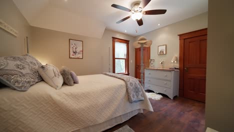 wide push in shot of a teenagers bedroom decorated with white and bright accents