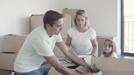 family with kids packing things for leaving