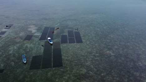 Aerial-view-boat-on-the-ocean-shallow,-circular-shot