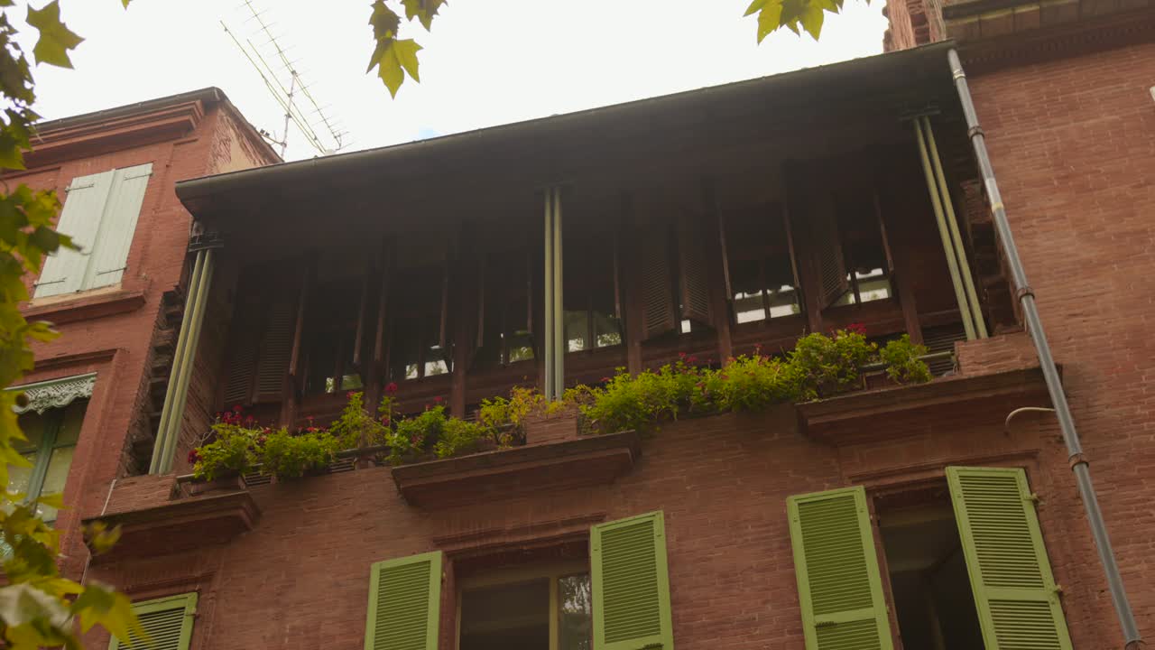Building with Brick Facade and Balcony