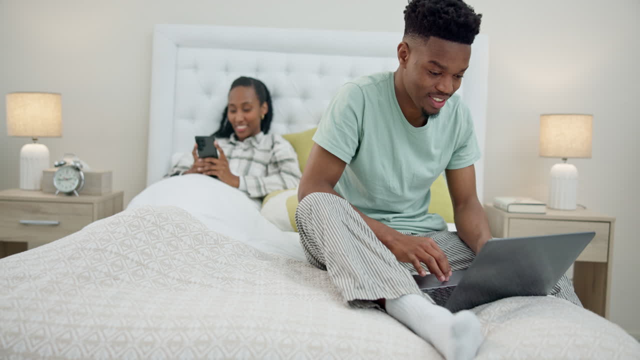 Laptop, phone and happy black couple relax in bed