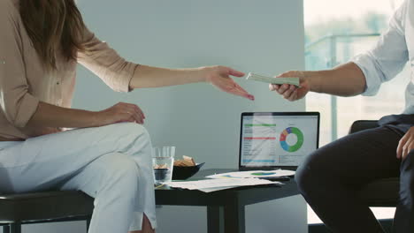 Closeup-hands-making-transaction-of-money.-Business-man-getting-wad-of-cash.