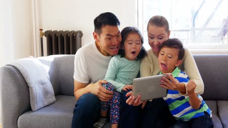 happy family using digital tablet in living room