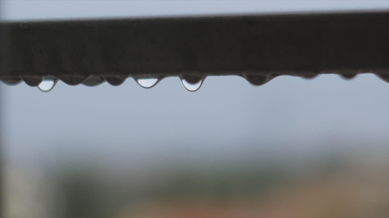 Detailed Rain droplet bouncing on steel balcony guard, heavy rain