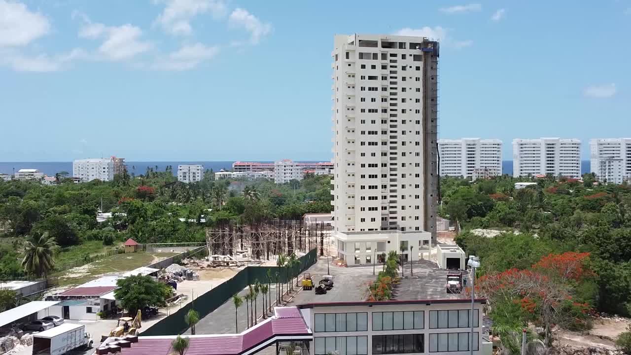 escena de drones desde arriba que muestra el edificio en construcción en la zona turística de juan dolio, antecedentes de hoteles turísticos