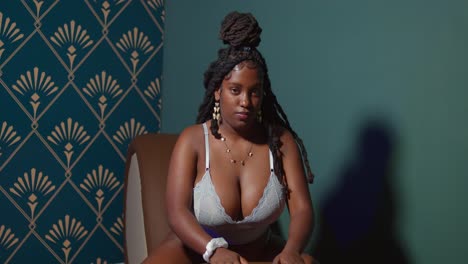 A moment of stunning beauty, with a Black girl in lingerie bathed in a cascade of brilliant indoor light