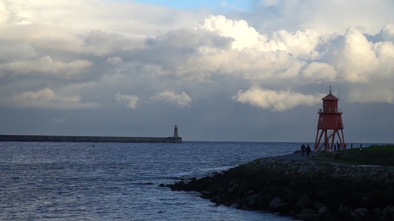 Dramatic Seascape with Lighthouses and People Walking