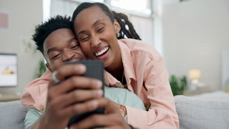 Couple,-hug-and-phone-on-home-sofa