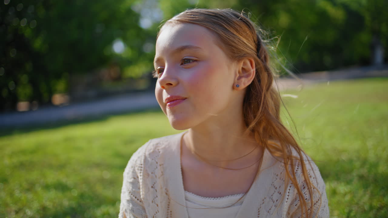 Kid enjoying mother touch sitting lawn closeup. Unrecognizable mum stroking girl