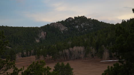 Evergreen-open-space-field-Colorado-Denver-Rocky-mountain-landscape-view-spring-snow-on-peaks-stunning-golden-yellow-cloudy-sunset-Conifer-Marshdale-14er-Idaho-Springs-zoom-in-slowly-motion